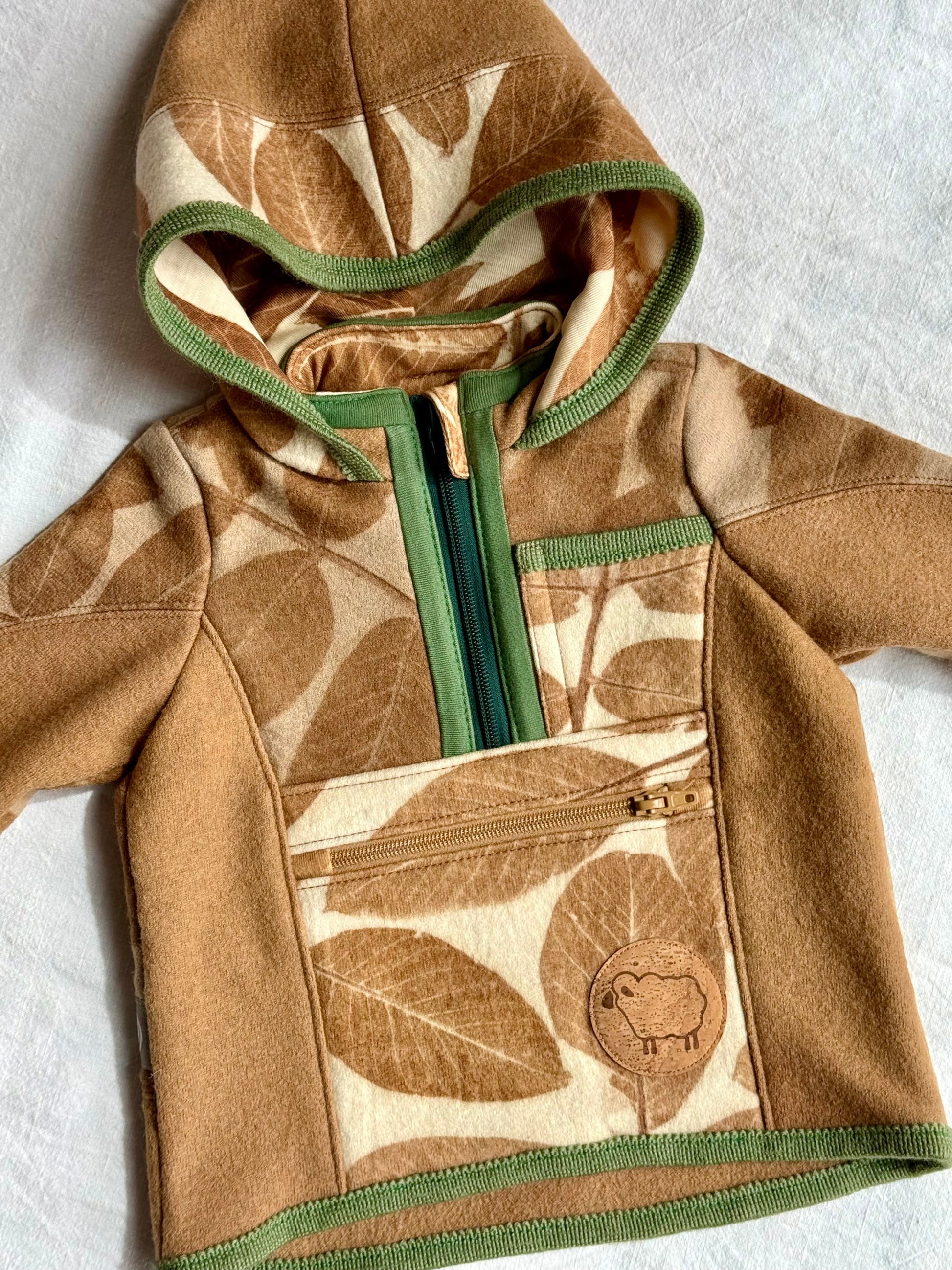 hooded sweater naturally dyed with walnut husks for kids, featuring walnut leaves pattern - close up of the front part