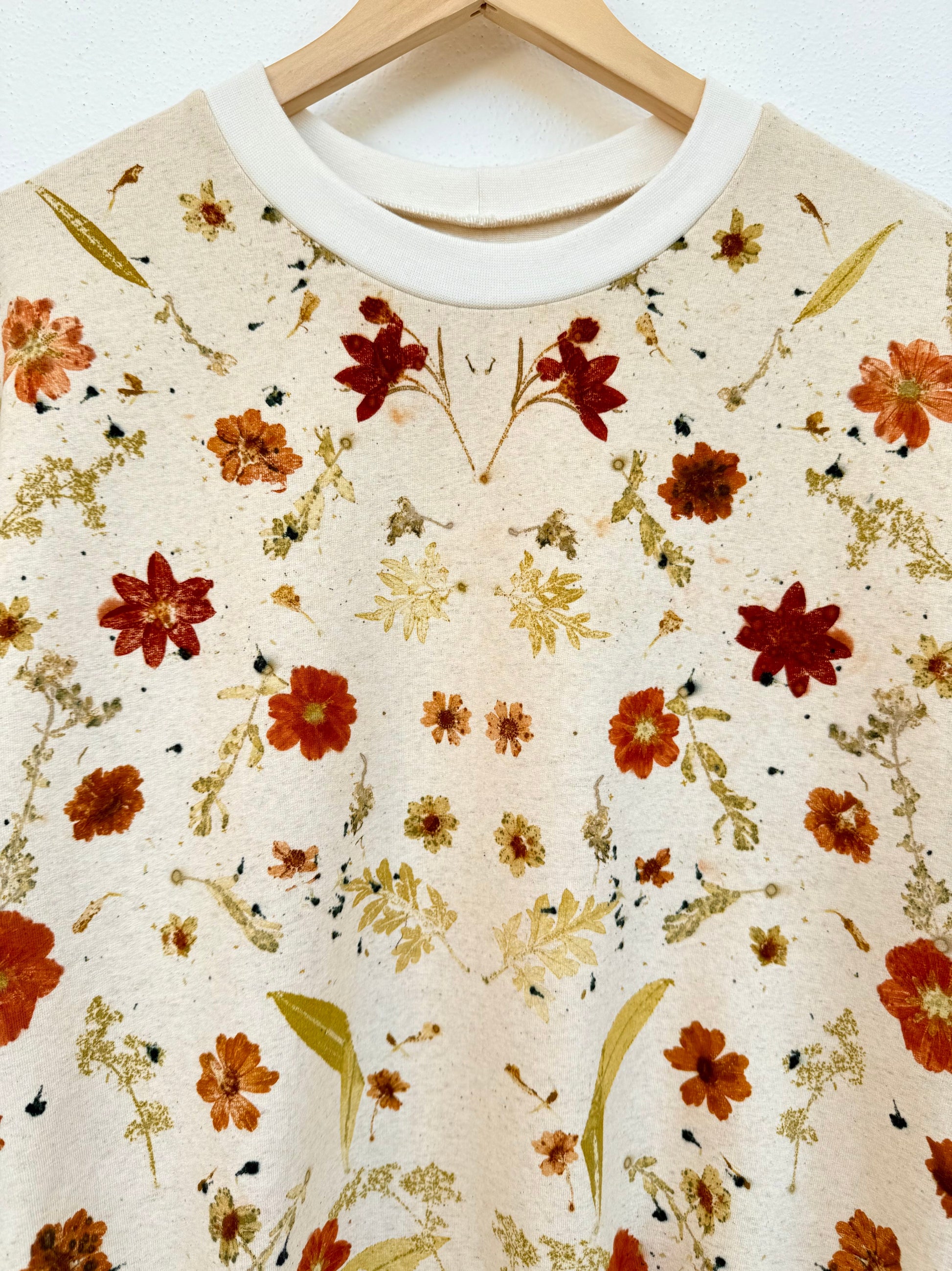Floral patterned , eco-printed boyfriend sweater on a hanger with a white background by DOT 'N' POT