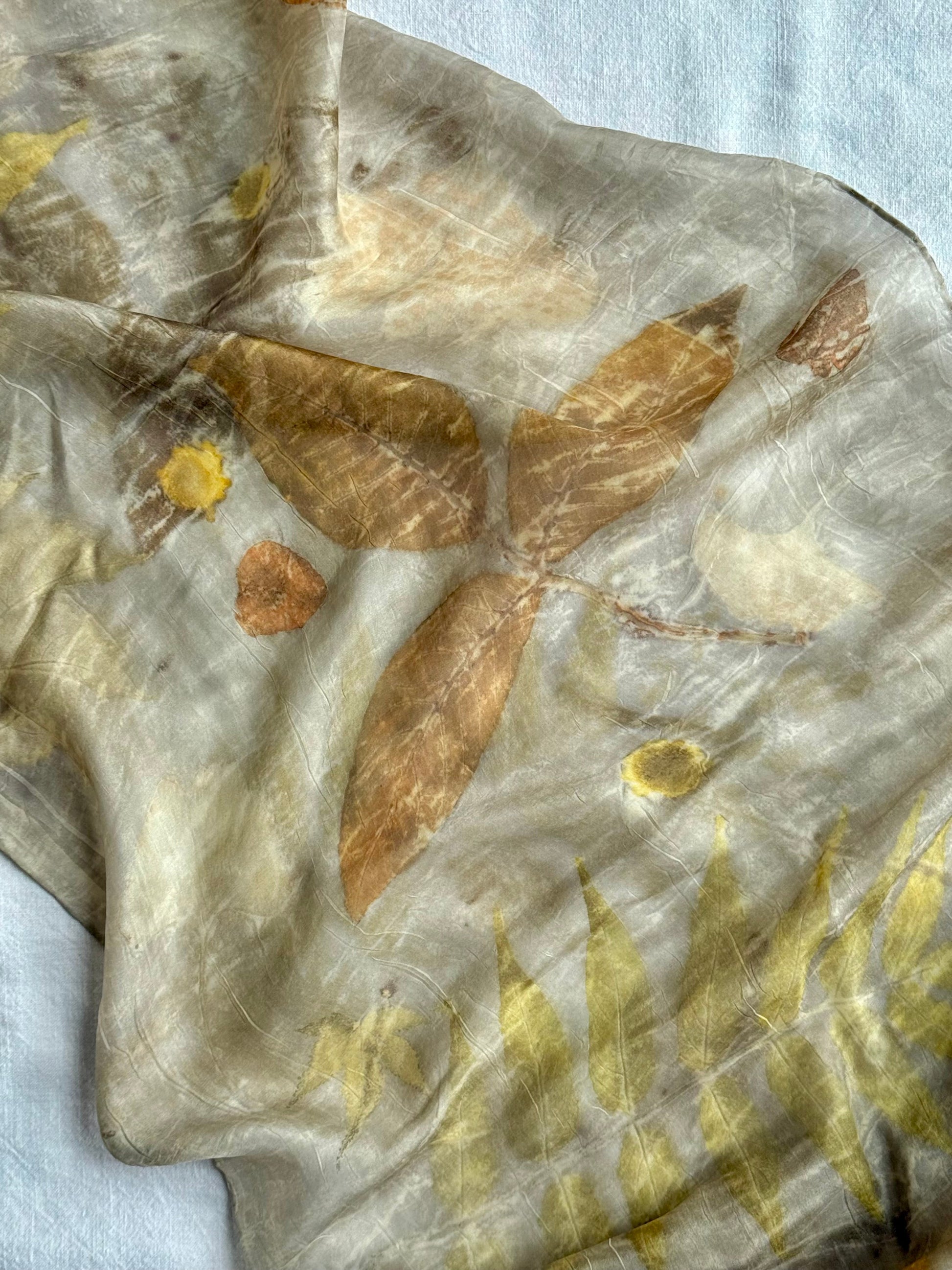 walnut leave eco-print on a naturally dyed silk scarf