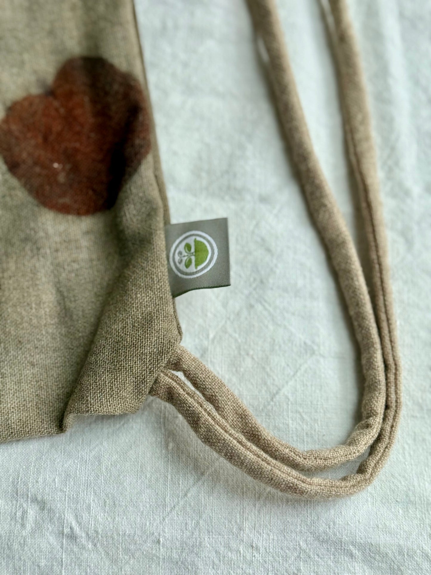 detail of a drawstring bag with brand logo by DOT 'N' POT