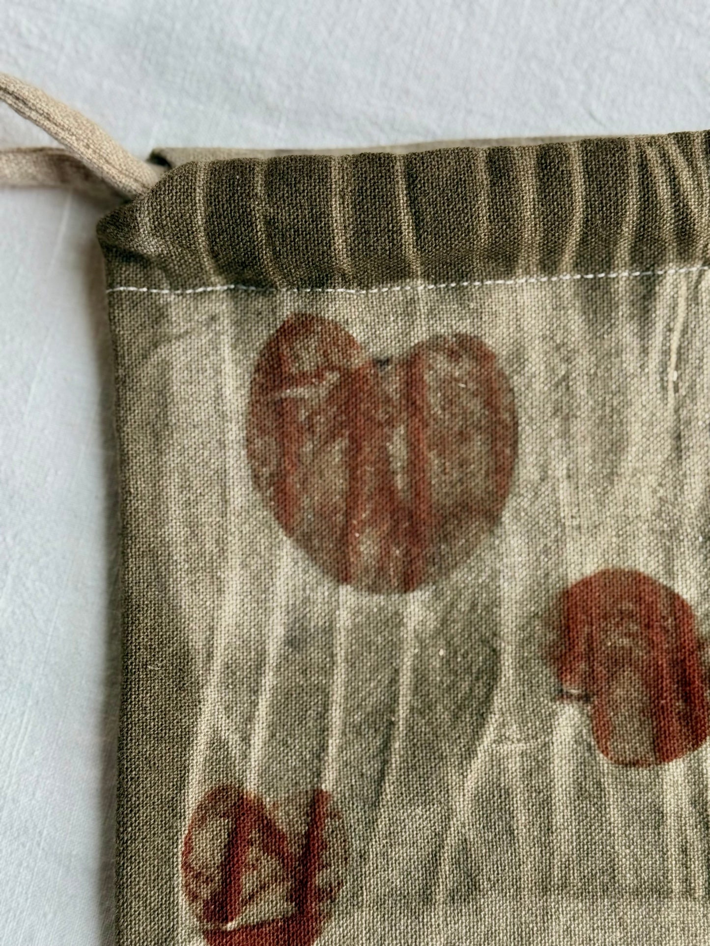 upper part with tie dye marks on a woolen drawstring bag