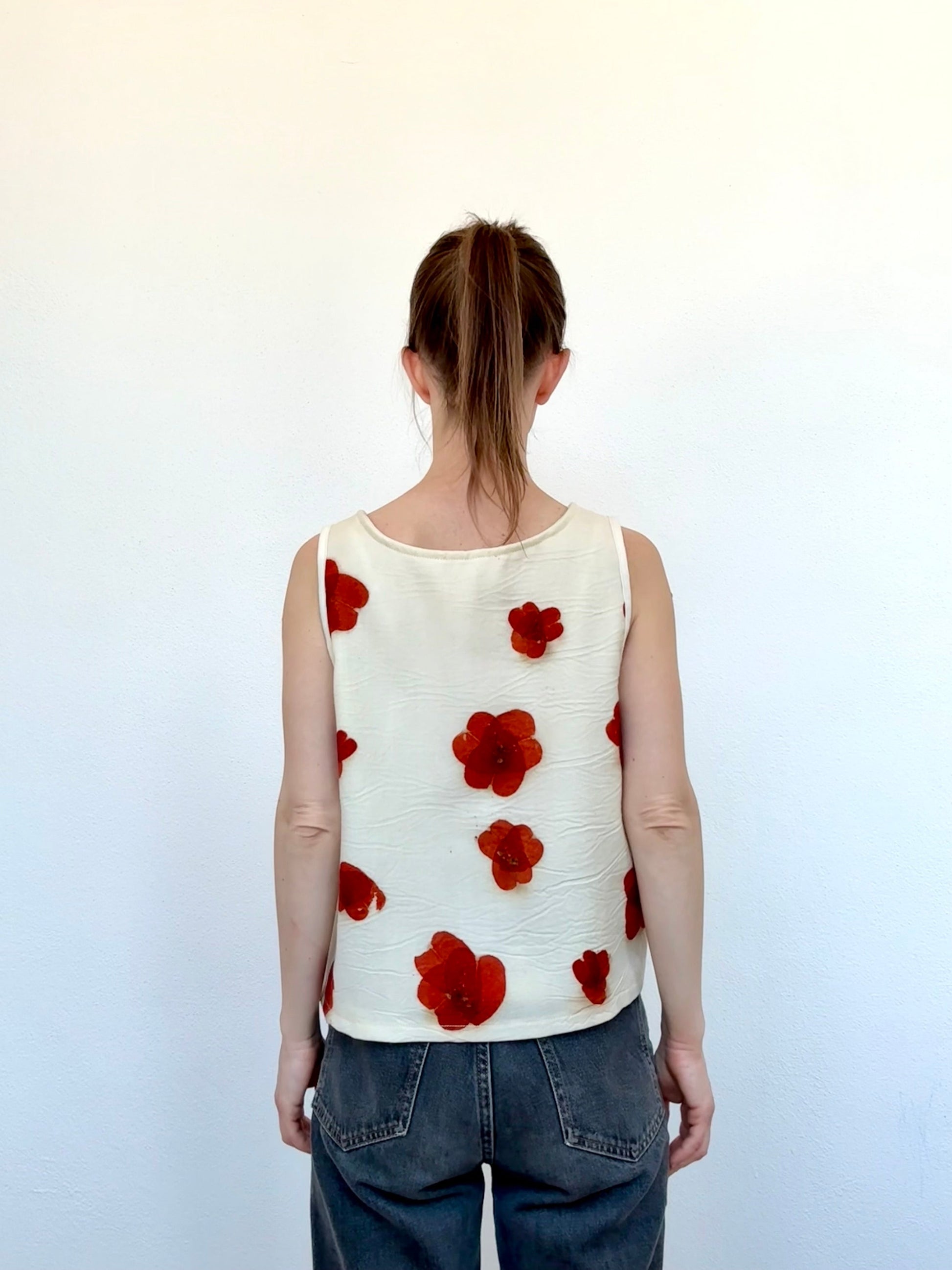 woman wearing an eco-printed merino wool top with eucalyptus leaves - back view