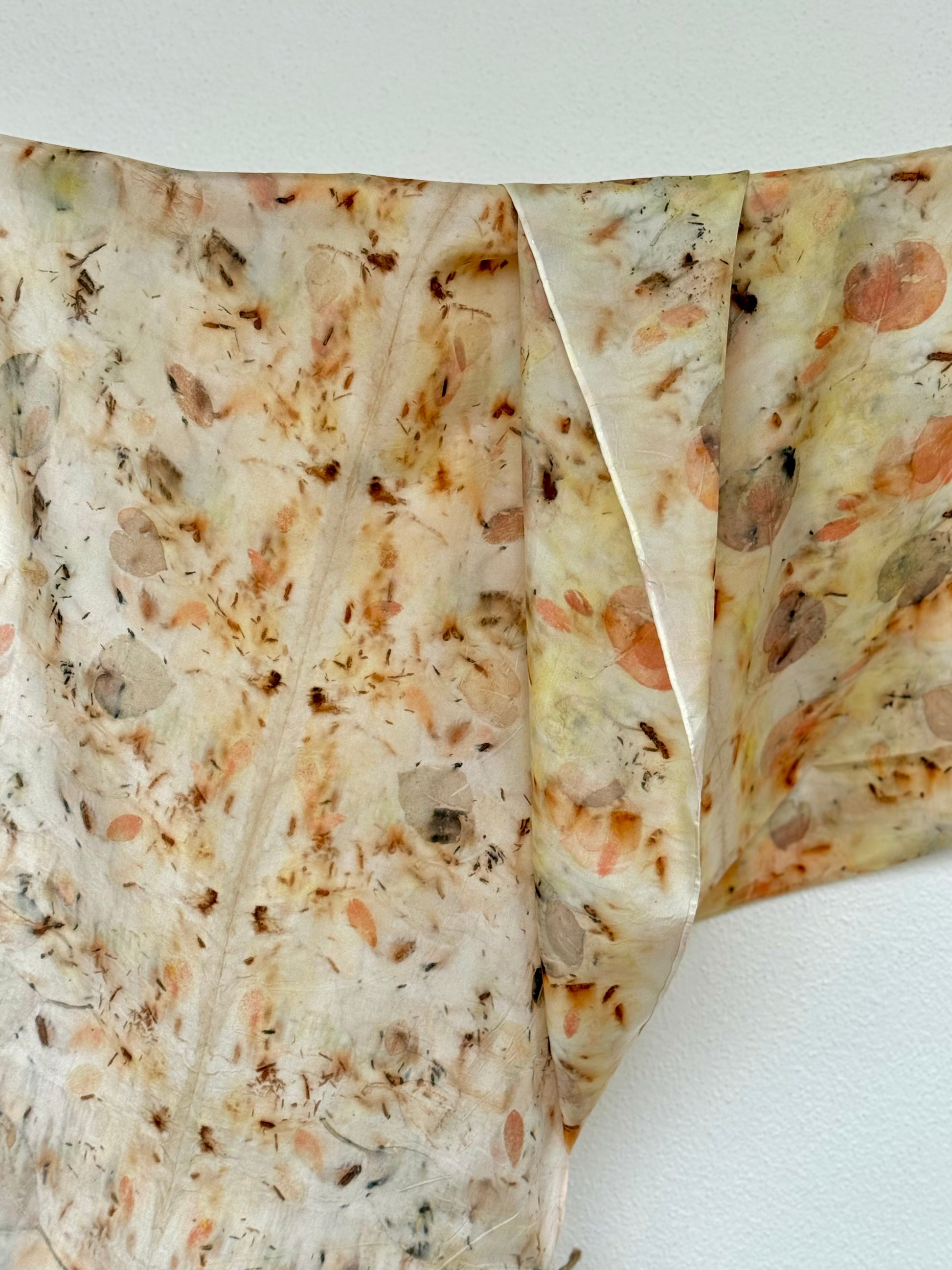 close-up of a silk scarf with natural eco-print made with eucalyptus, logwood and safflover 