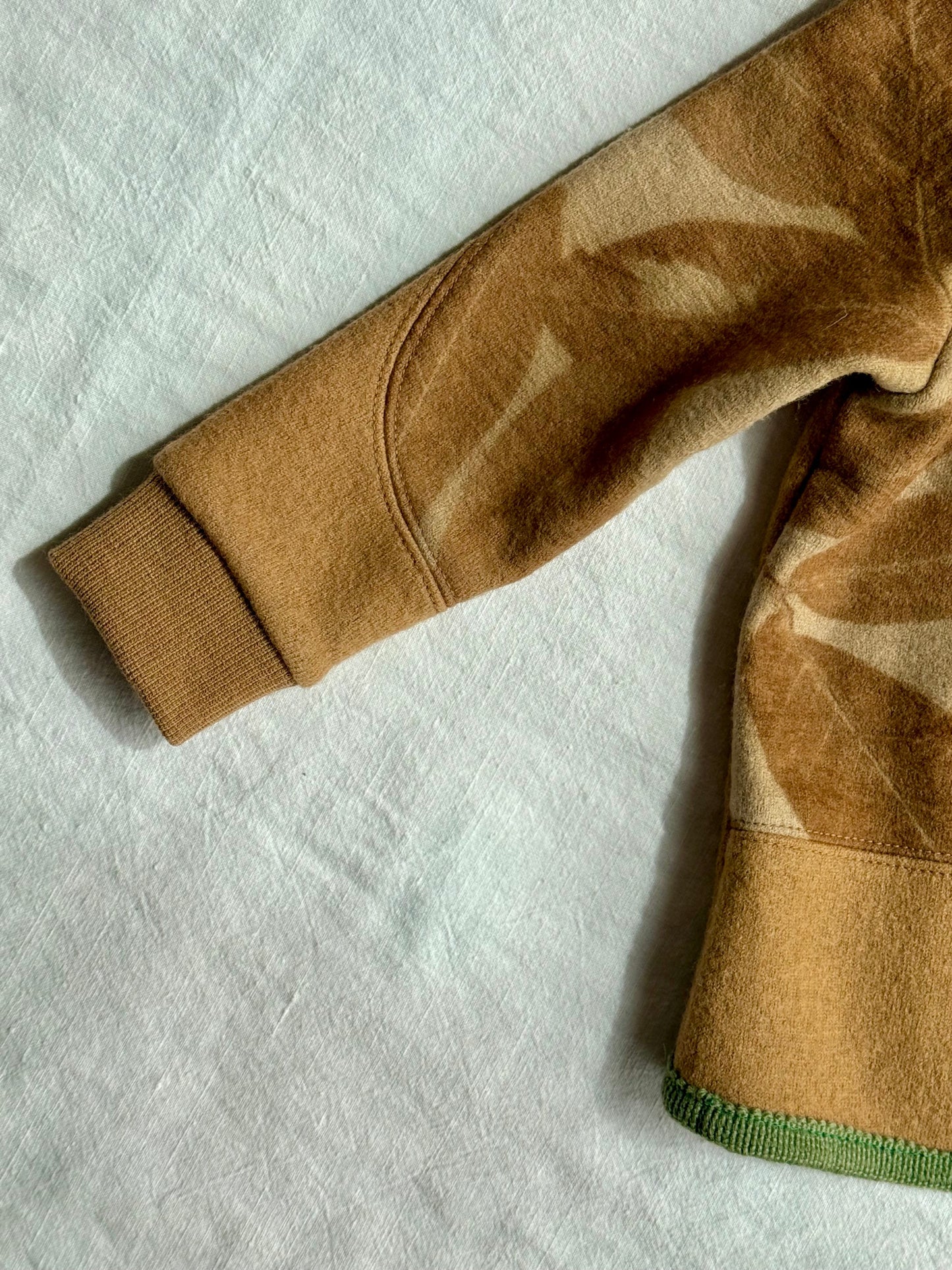 sleeve detail of a kids hoodie made of naturally dyed brown merino wool