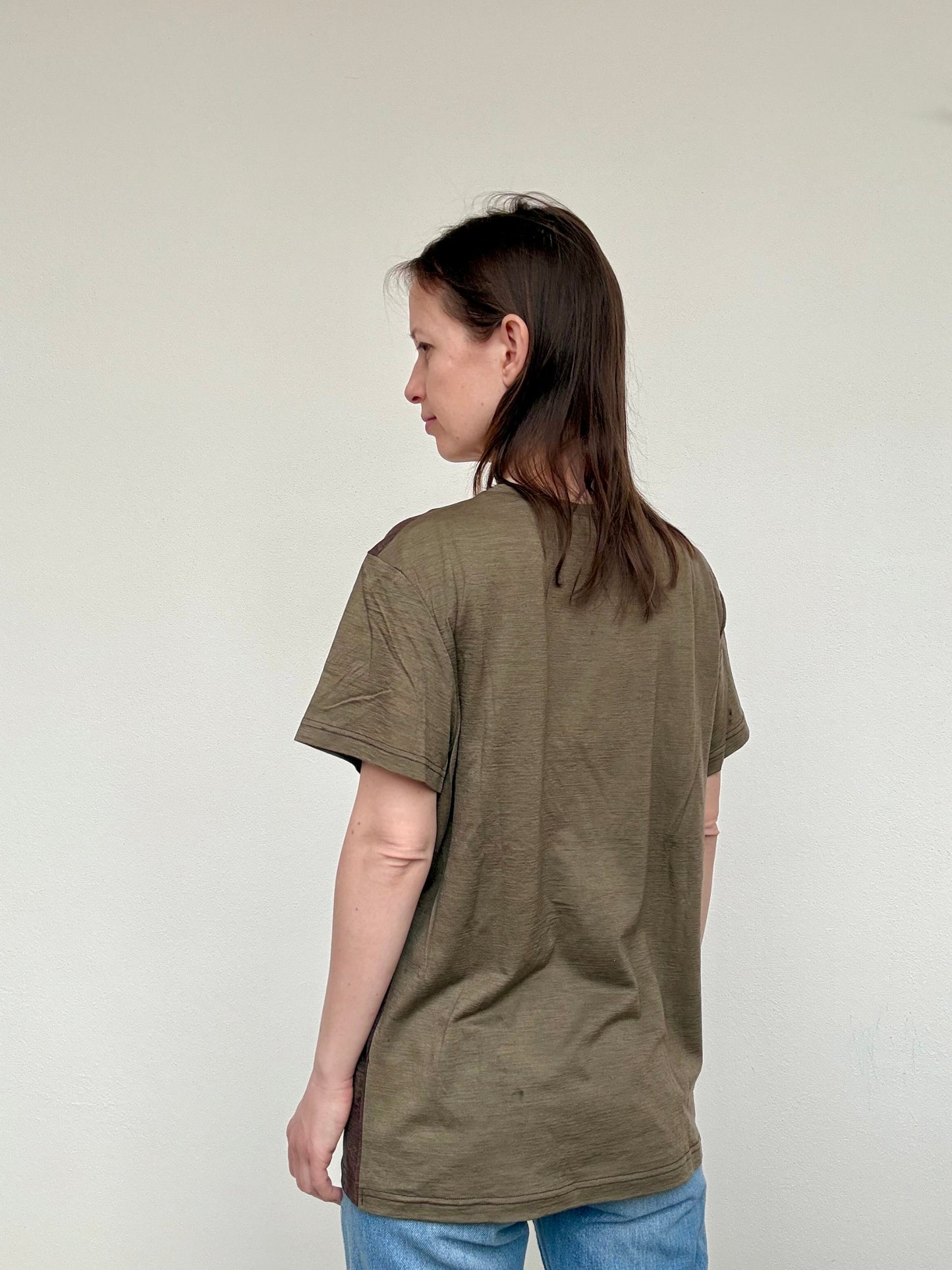 women standing in a naturally dyed merino t-shirt with sweet chestnut - look and colour of the back part