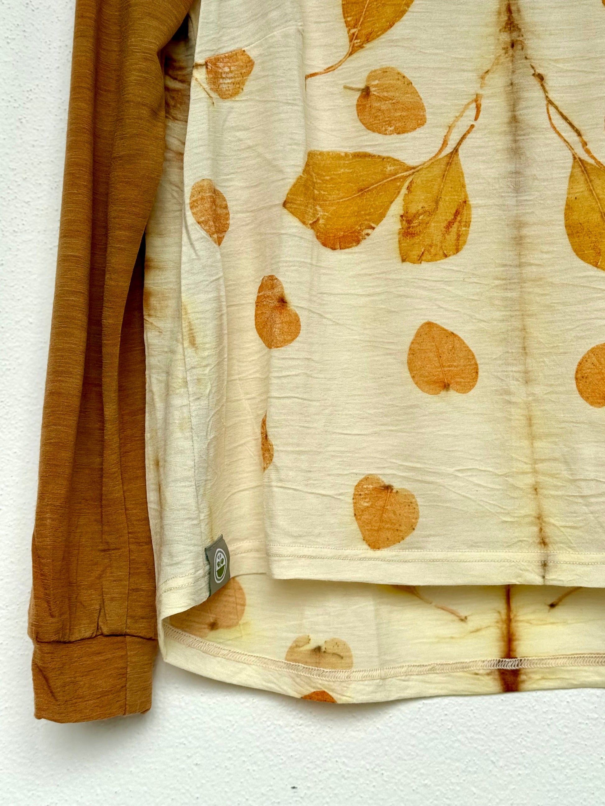 merino wool top detail with naturally dyed orange sleeve and eucalyptus leaves pattern