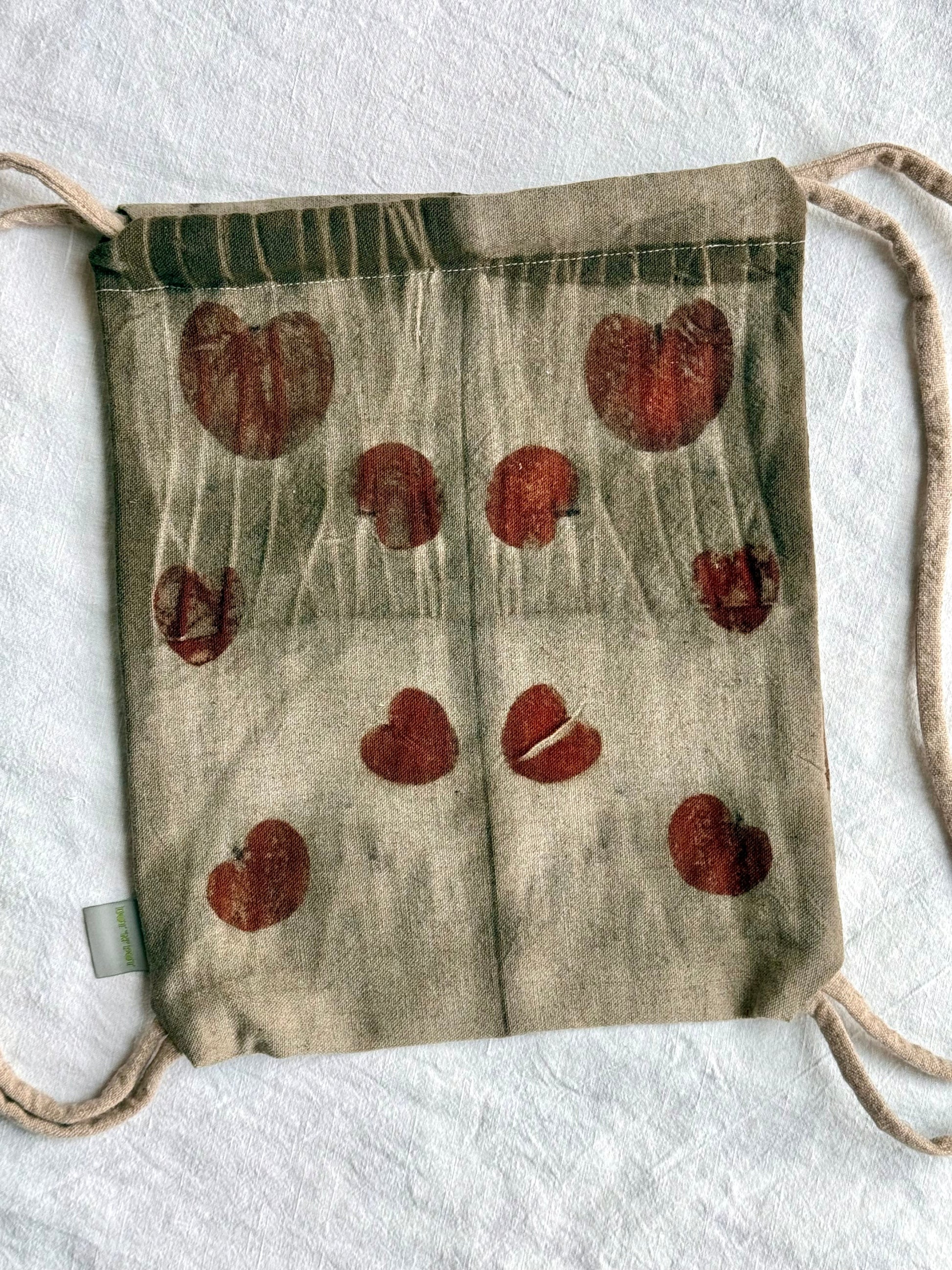back part with eucalyptus leaves eco-printed on a woolen drawstring bag with tie dye gray marks by DOT 'N' POT