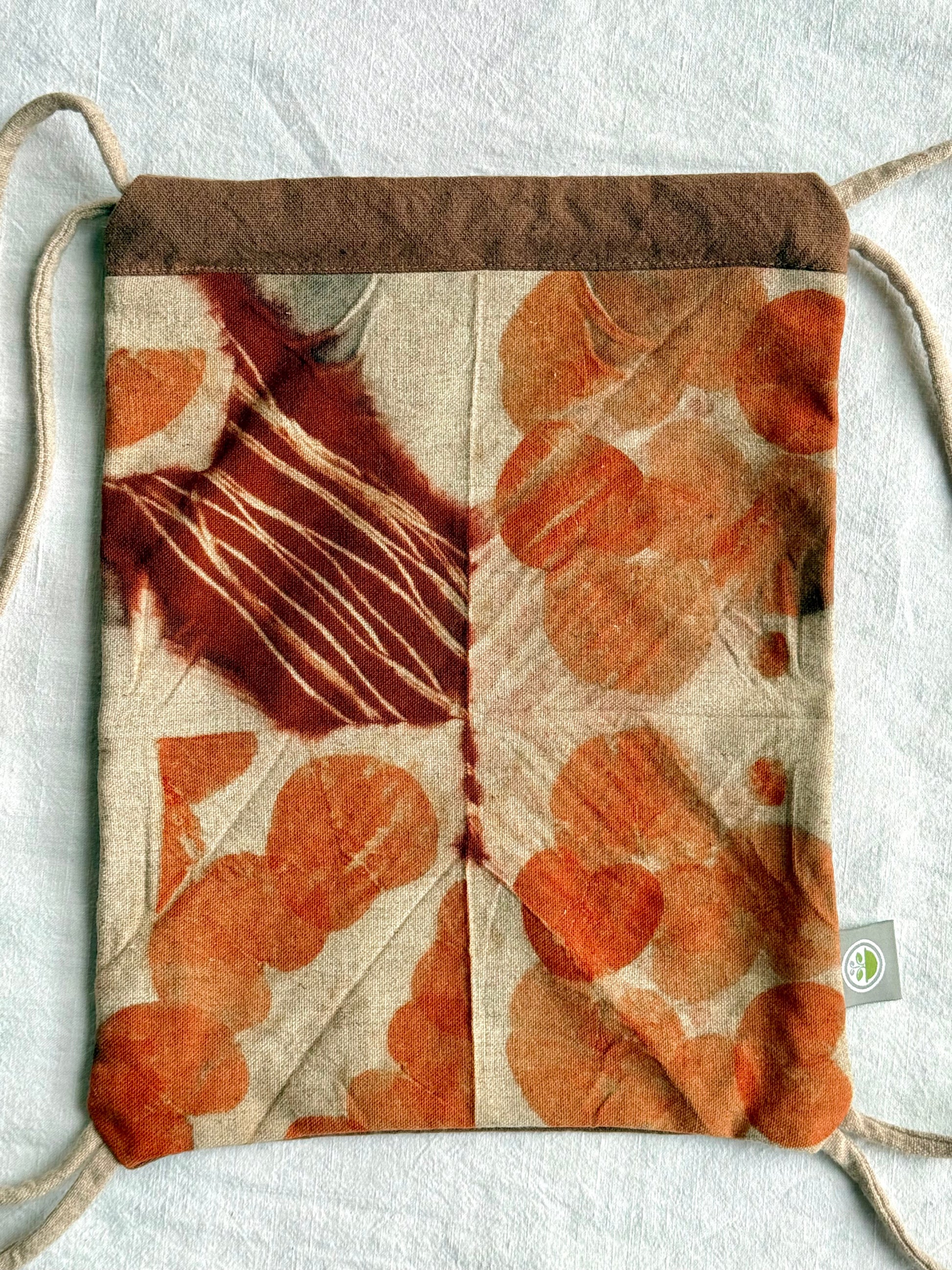 front of a naturally dyed and eco-printed eucalyptus woolen bag by DOT 'N' POT