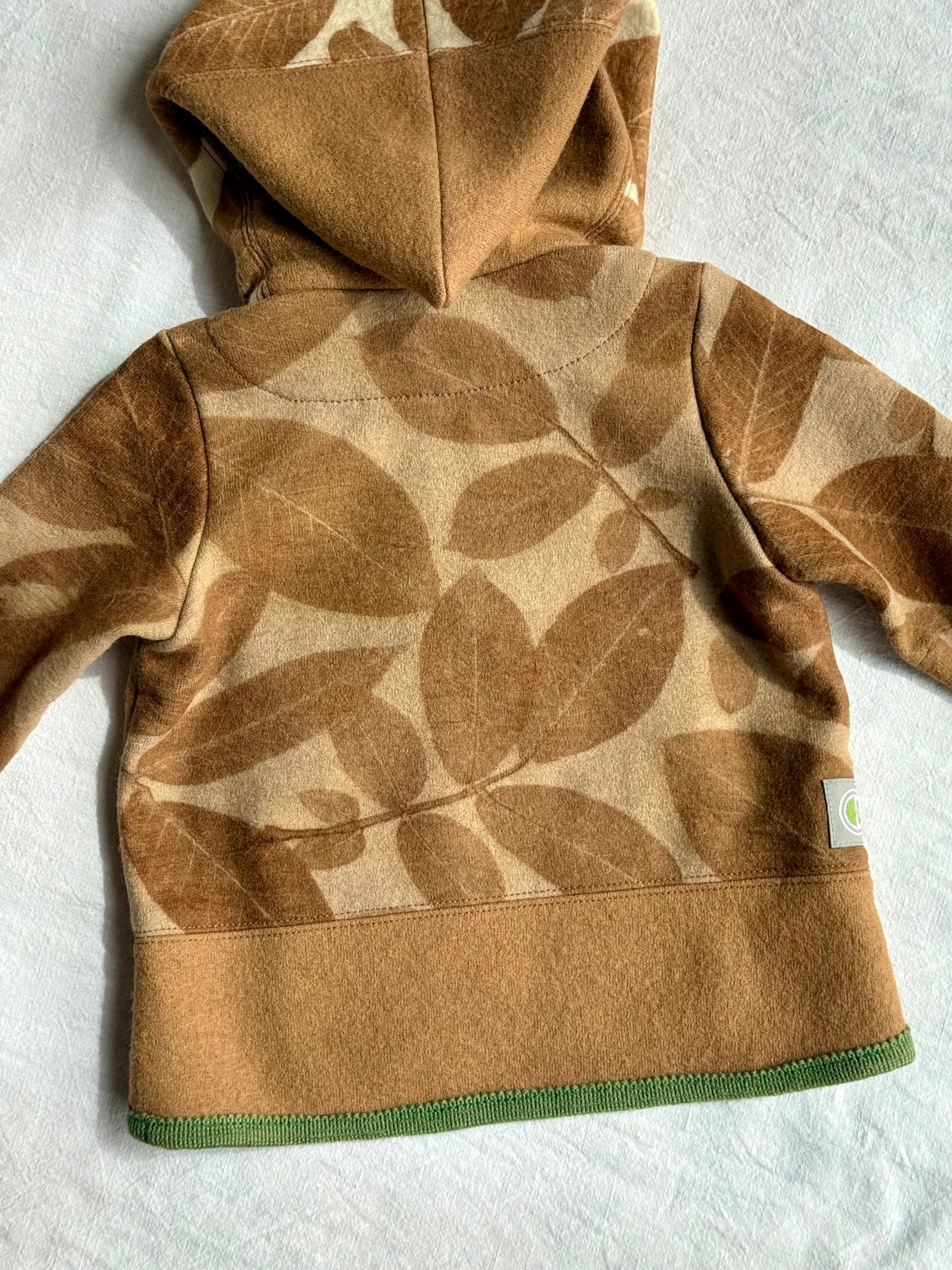 back part of a kids hoodie naturally dyed brown with walnut husks and walnut leaves 