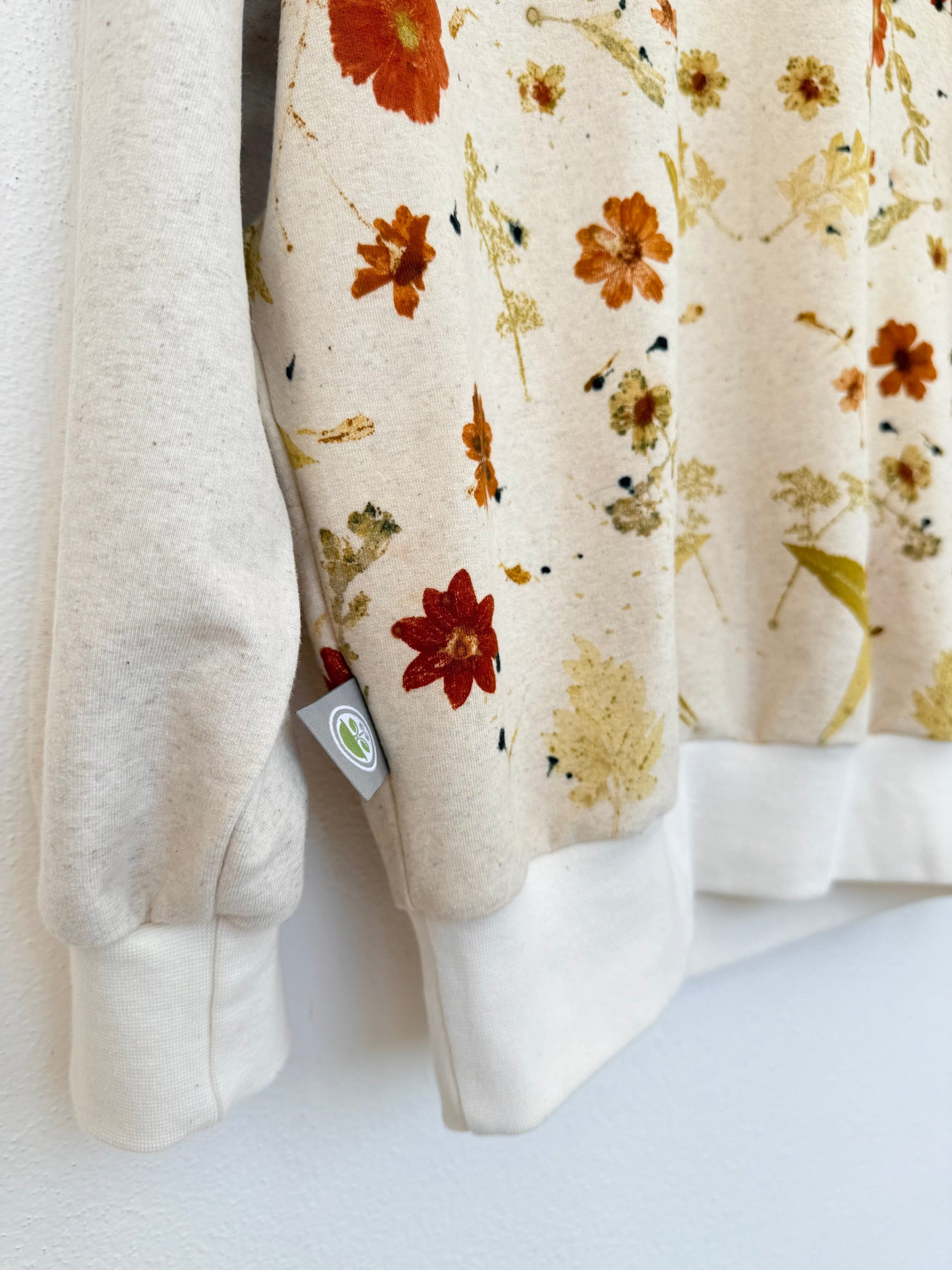 Eco-printed sweater with a visible tag by DOT 'N' POT - close-up