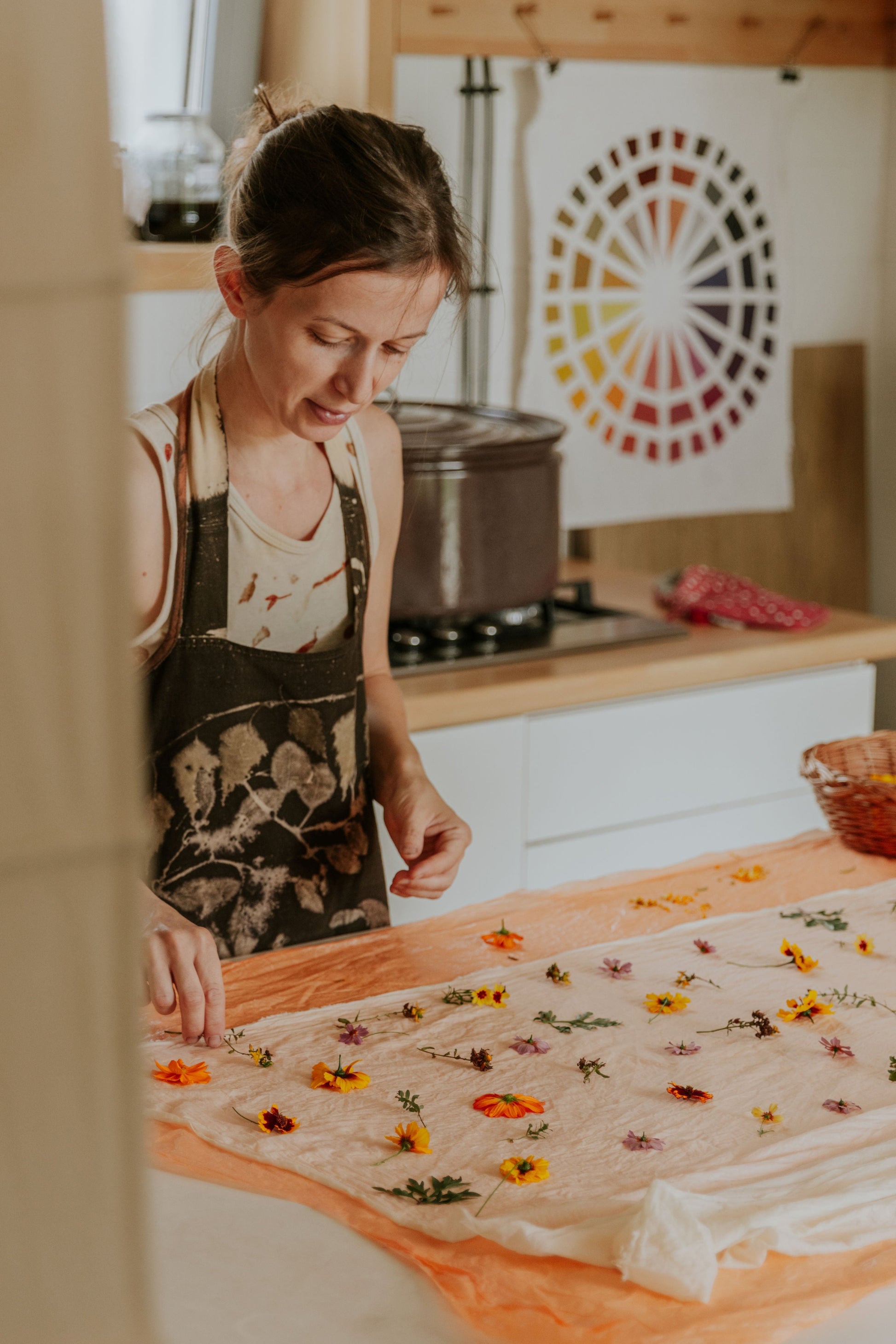 Ildikó in her DOT 'N' POT studio kitchen eco-printing with flowers on cotton fabric