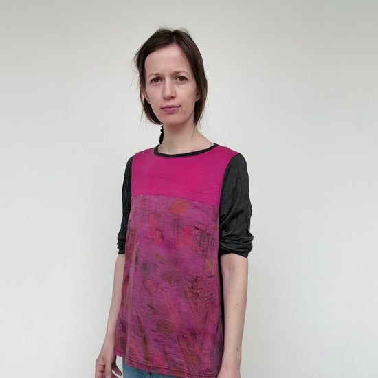 woman wearing a merino wool top dyed with cochineal, eco-printed with various plants 