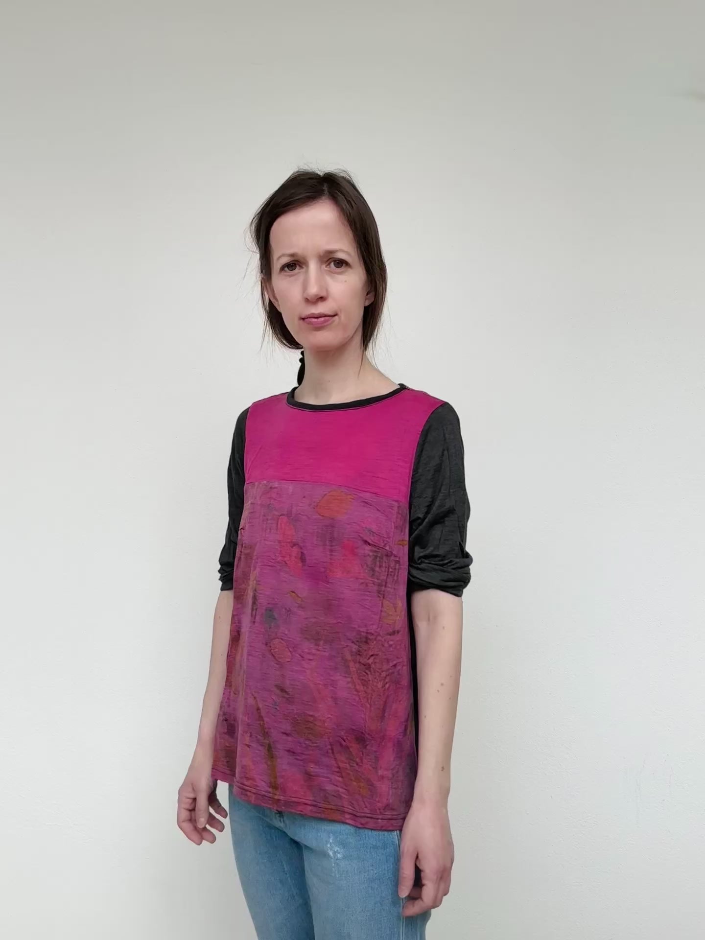 woman wearing a merino wool top dyed with cochineal, eco-printed with various plants 